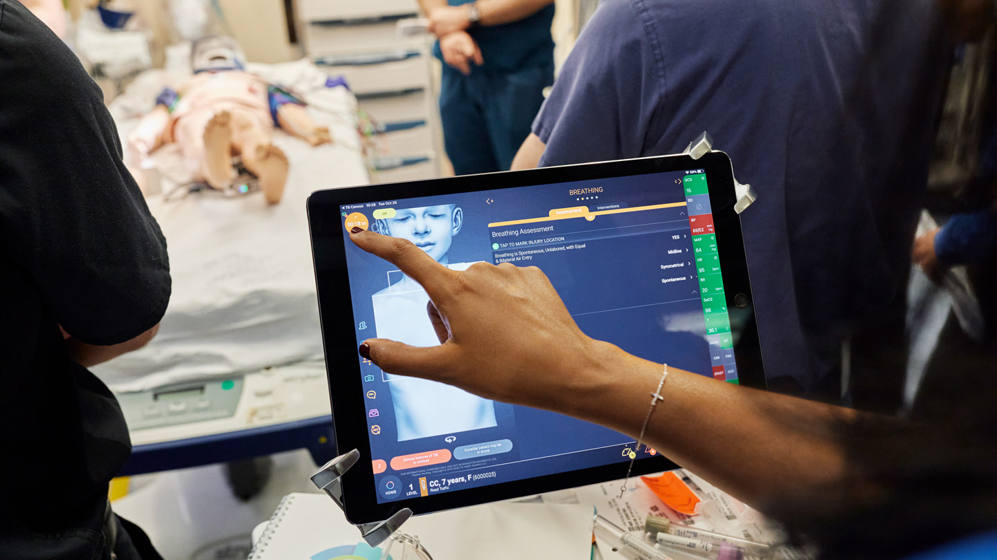 A trauma team uses the iPad app T6 to treat a patient.