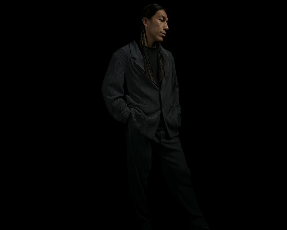 A model poses against a black backdrop.