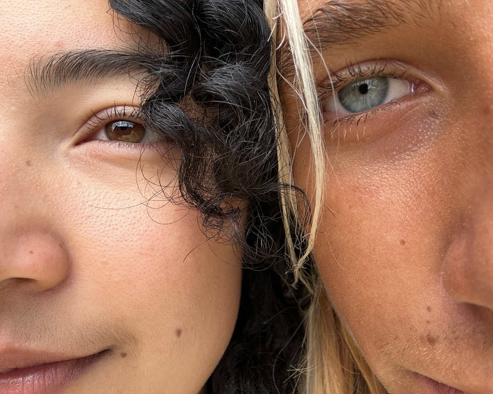 The faces of two people with their heads tilted toward one another are shown in extreme close-up in this image shot on iPhone.