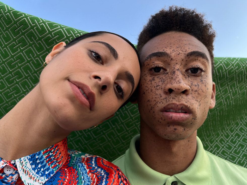 A portrait of two people shot with the Wide camera on iPhone 13. 