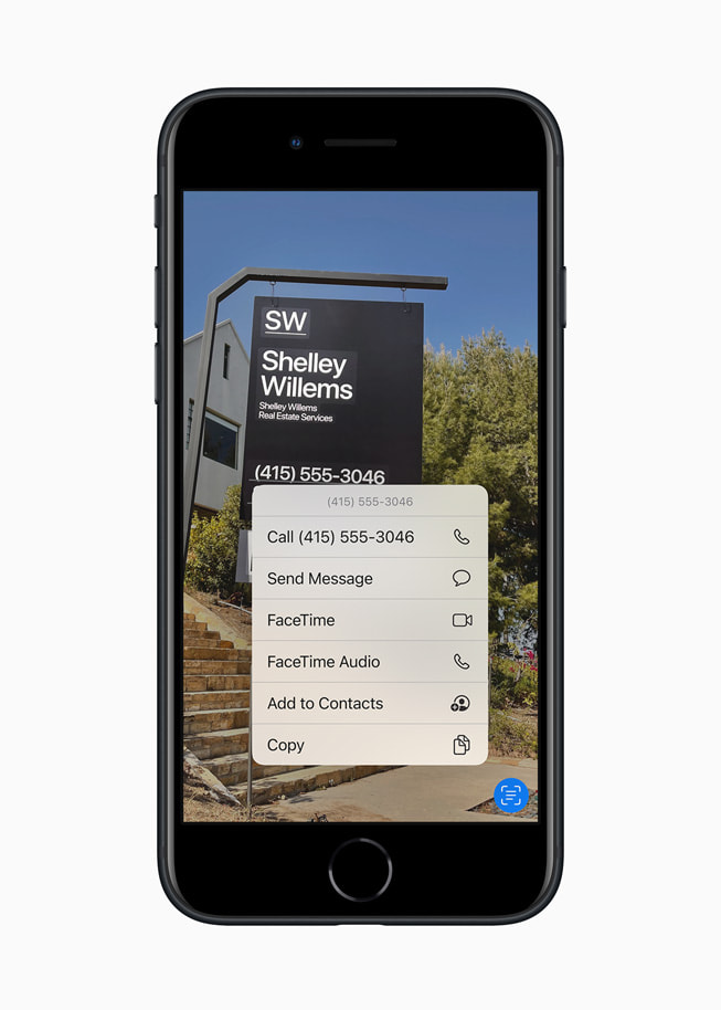 The new iPhone SE in midnight using iOS 15’s Live Text feature on a realtor sign.