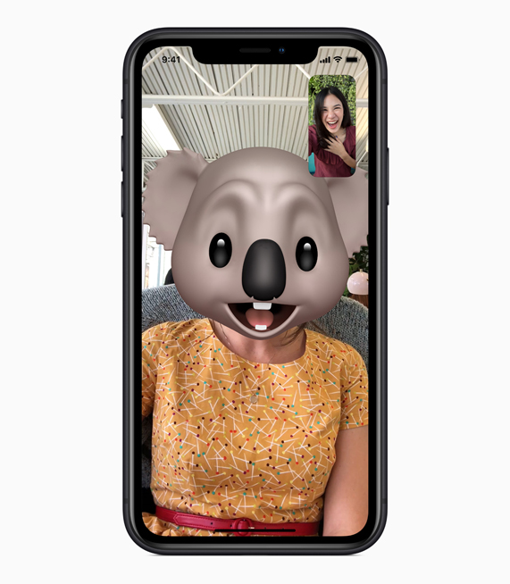 iPhone XR with Animoji FaceTime on screen.