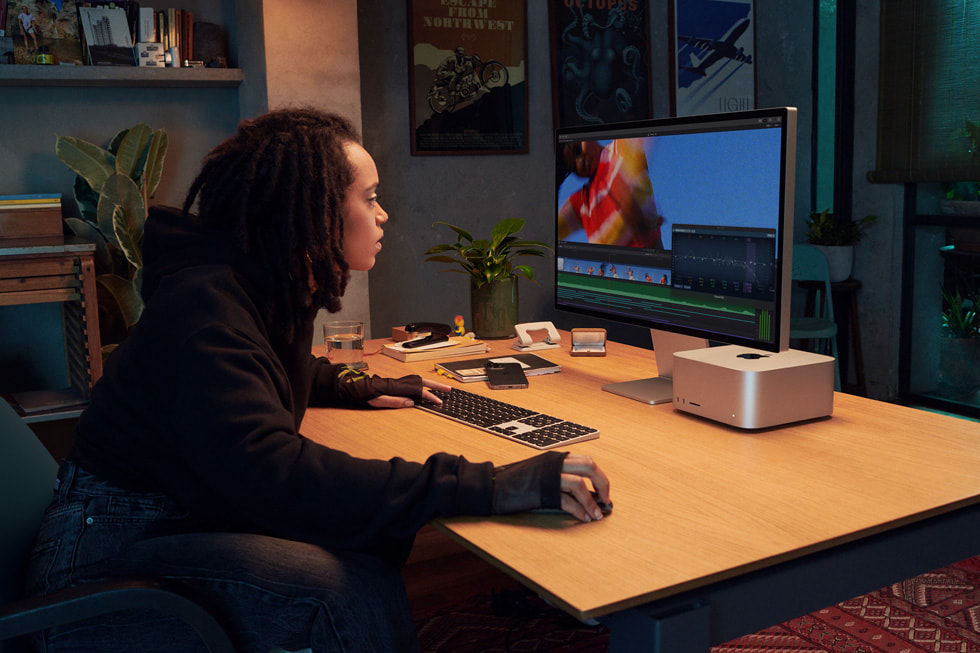 Một chuyên gia sáng tạo sử dụng Mac Studio trong môi trường văn phòng.