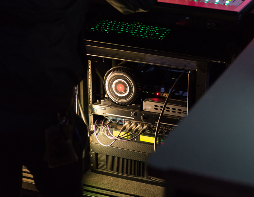 Mac Pro backstage connected to a soundboard.