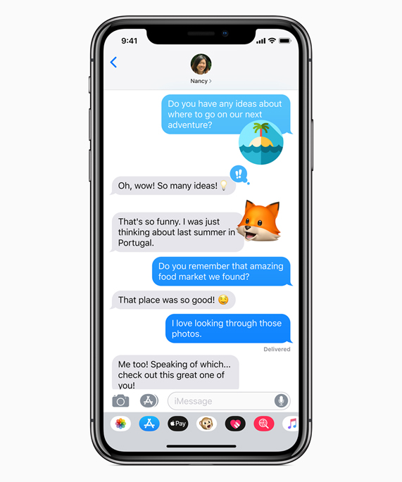 iPhone X showing Messages with Memojis.