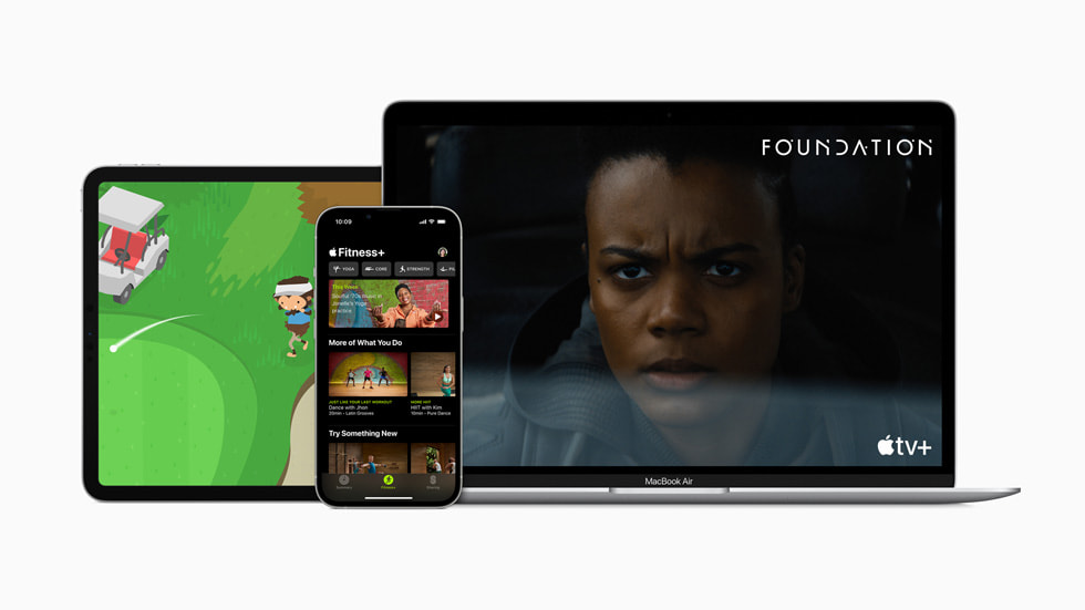 iPad Pro displaying Apple Arcade, iPhone 13 Pro displaying Fitness+, and MacBook Air displaying Apple TV+. 