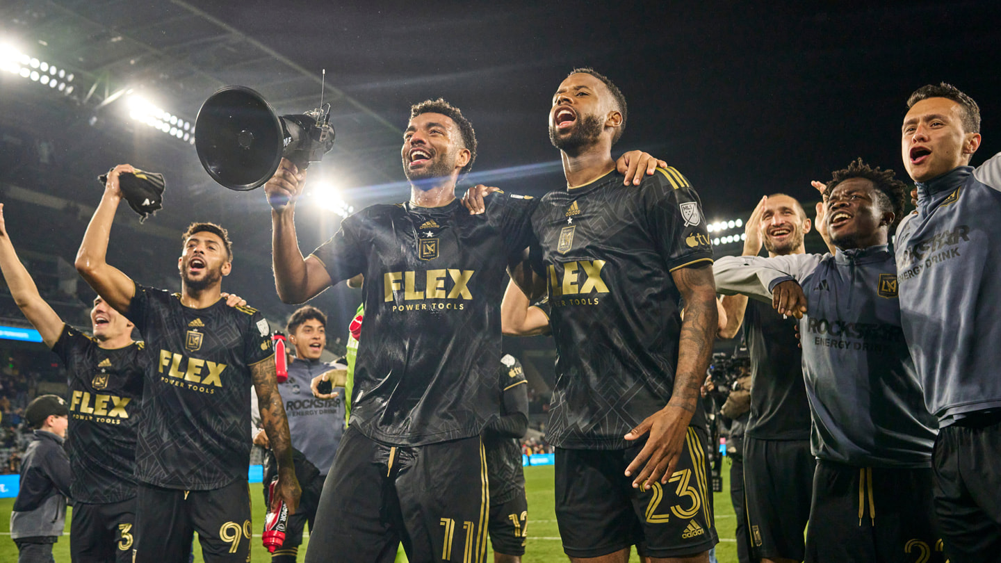 LAFC players celebrate on the field at BMO Stadium after a victory against the New England Revolution.