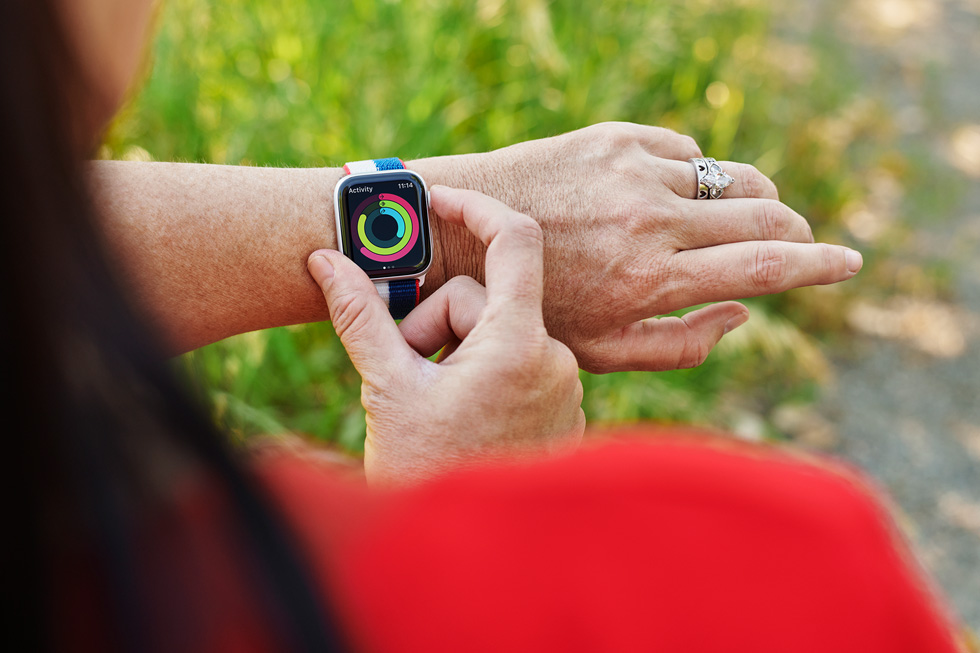 Amy Van Dyken checking her Activity rings on Apple Watch Series 6 wearing a US International Collection Sport Loop.