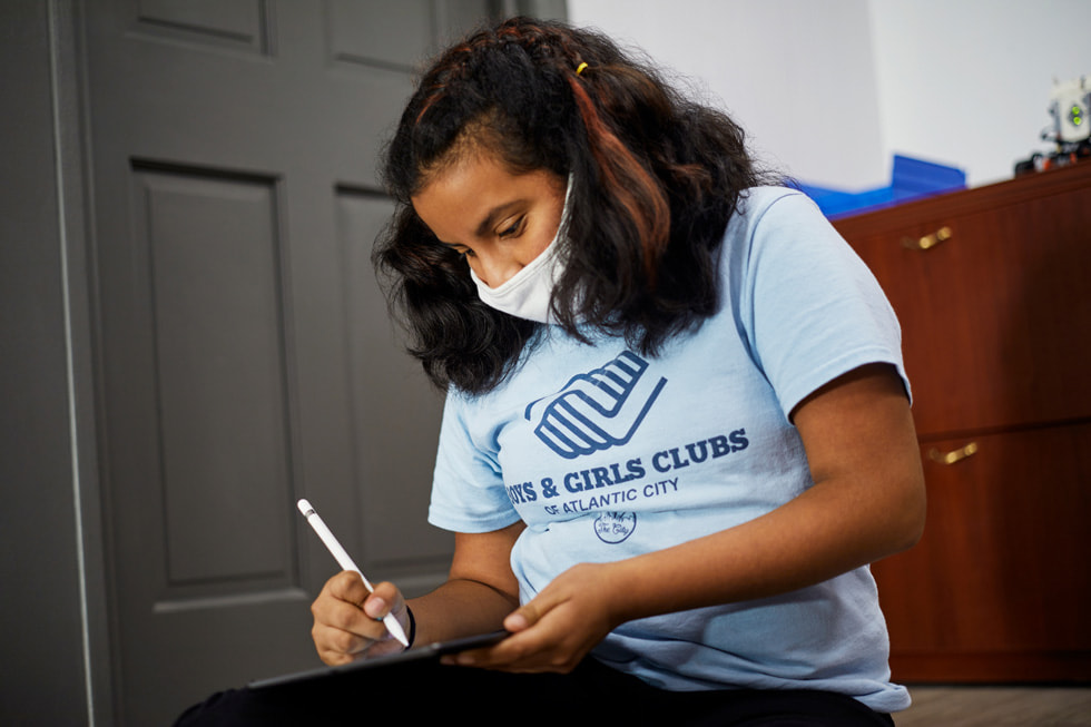A young learner from Boys & Girls Clubs of Atlantic City works on iPad.