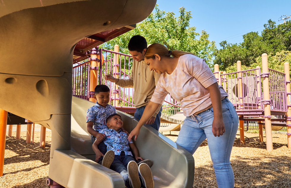 Alma Rodriguez and her three sons playing in the playground.