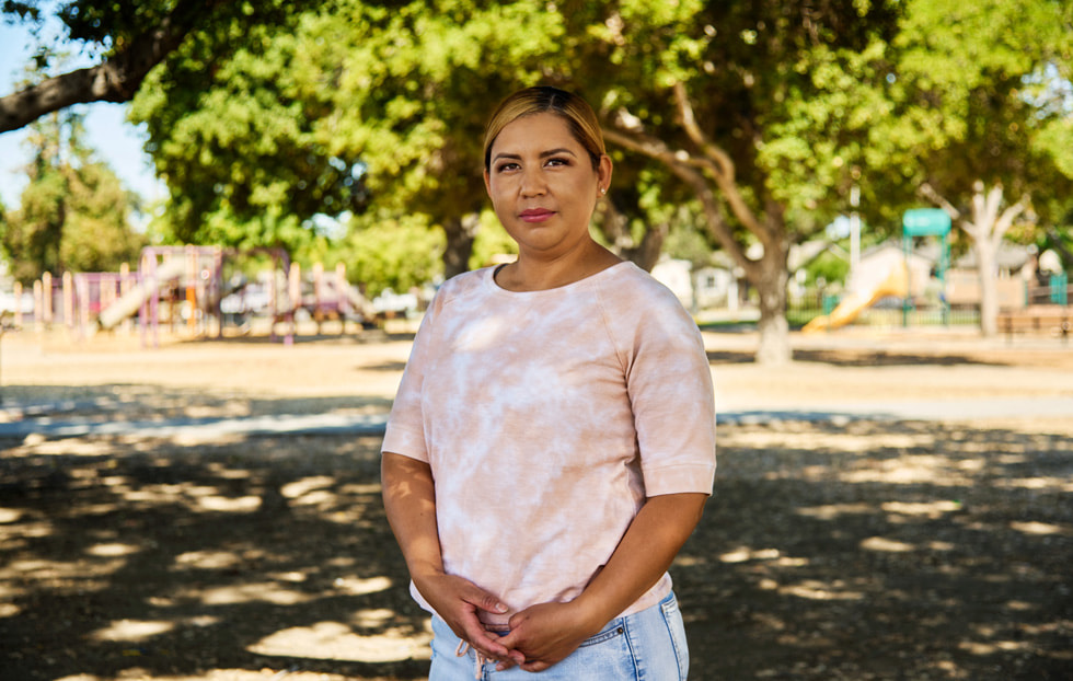 Alma Rodriguez standing in front of a park.