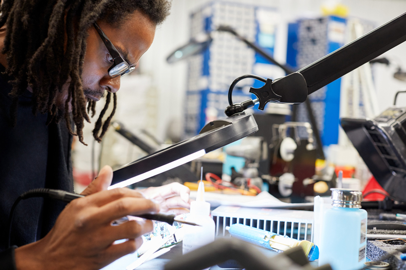 A Maccor employee tinkering with the company’s battery testing equipment.