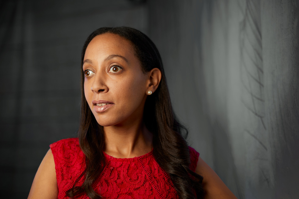 Haben Girma wearing a red lace blouse.