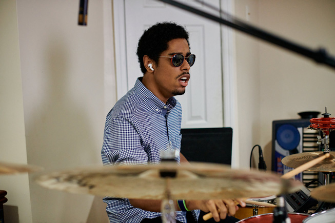 Mathew Whitaker plays the drums at his home.