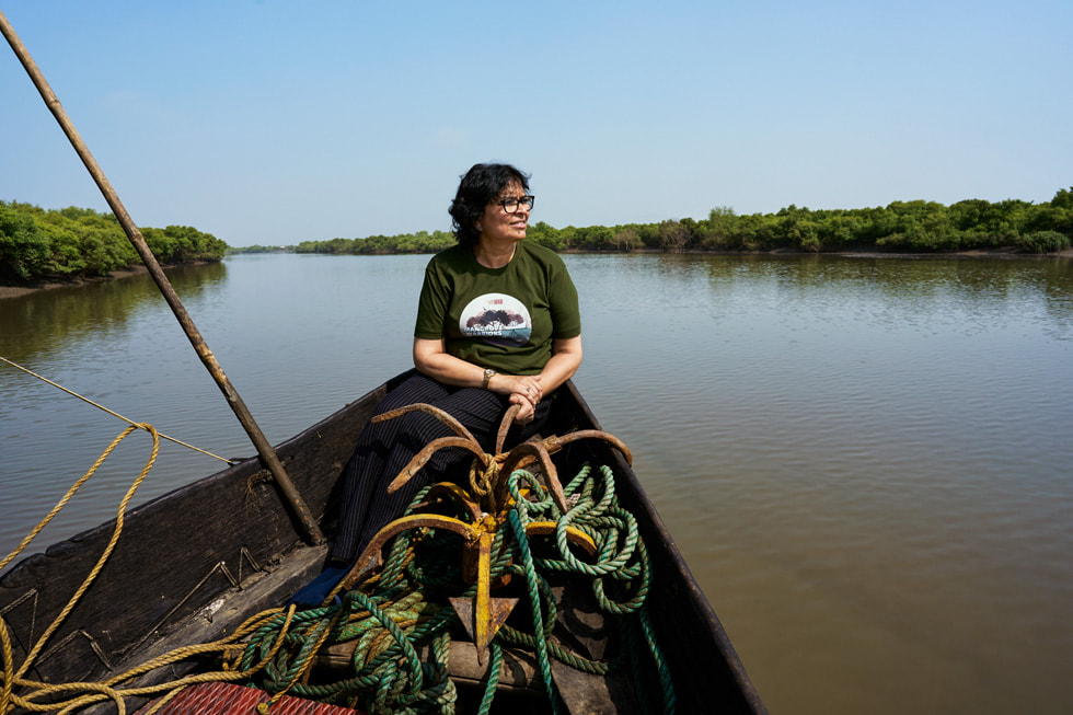 Applied Environmental Research Foundation director Archana Godbole is shown in a canoe on a river in India.