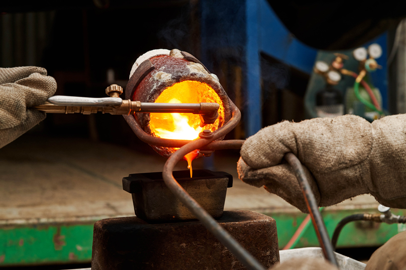 Heated gold being poured into bars.