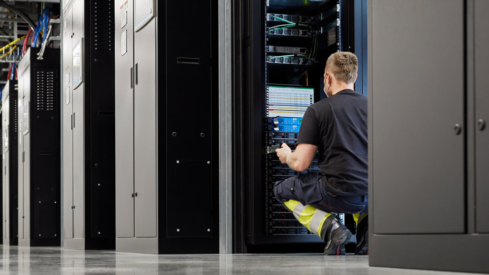 A worker in a server room at the Viborg data center.