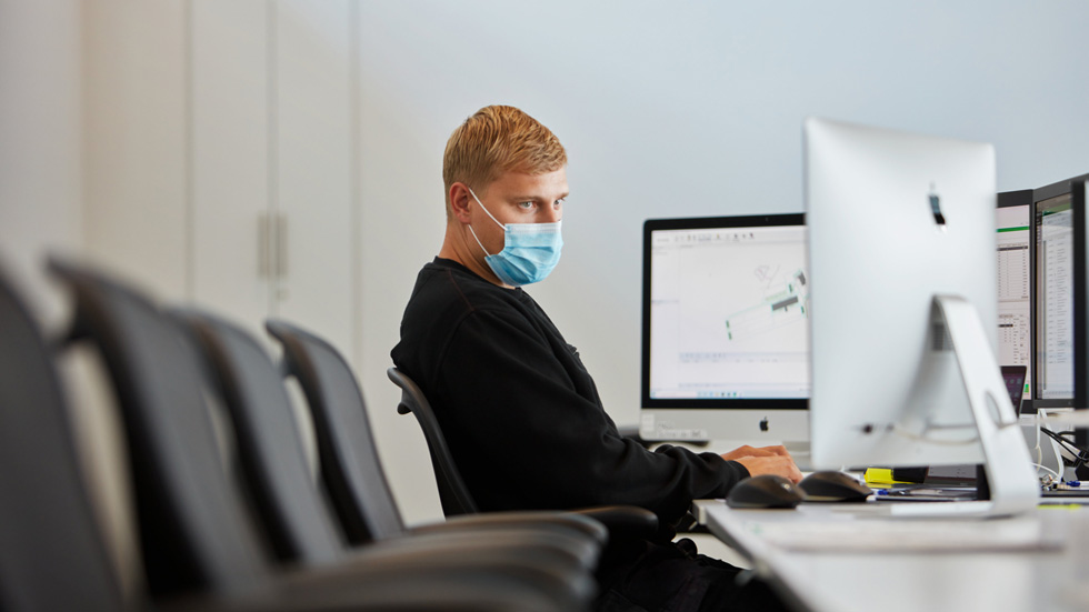 Employee working in a light-filled office space at the Viborg data center.