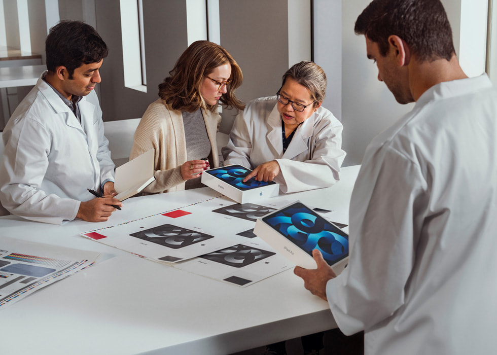 A team inspects the packaging for iPad Air.