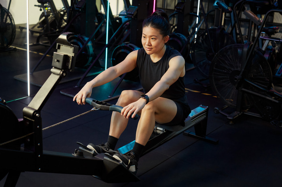 A woman tracking her rowing exercise with her Apple Watch, powered by LumiHealth.