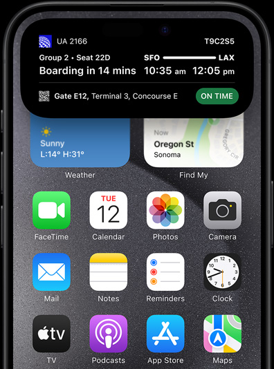 iPhone 15 Pro with Dynamic Island showing live sports scores