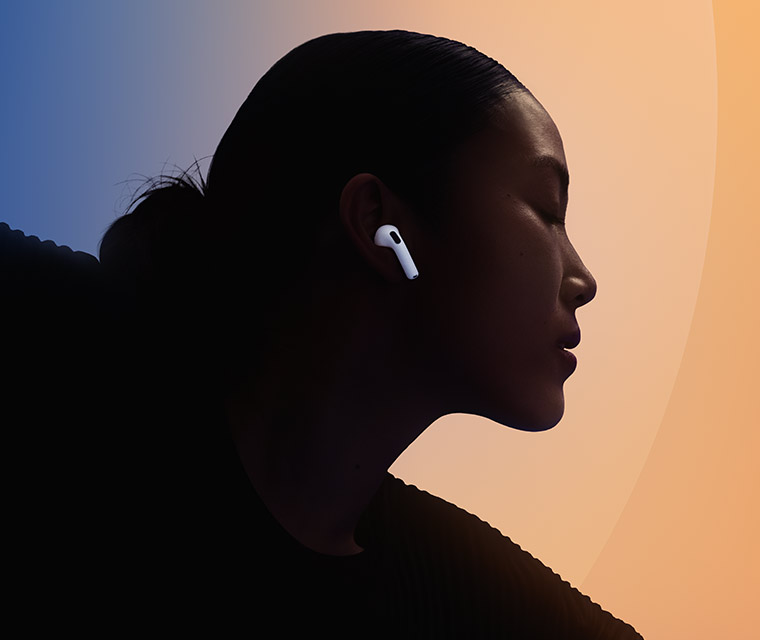 A person wearing one of the white AirPods 5 in their ear