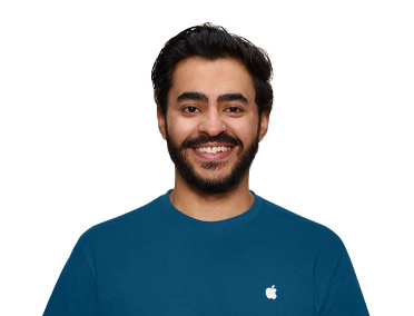 An Apple Store Specialist smiling, wearing a blue Apple shirt
