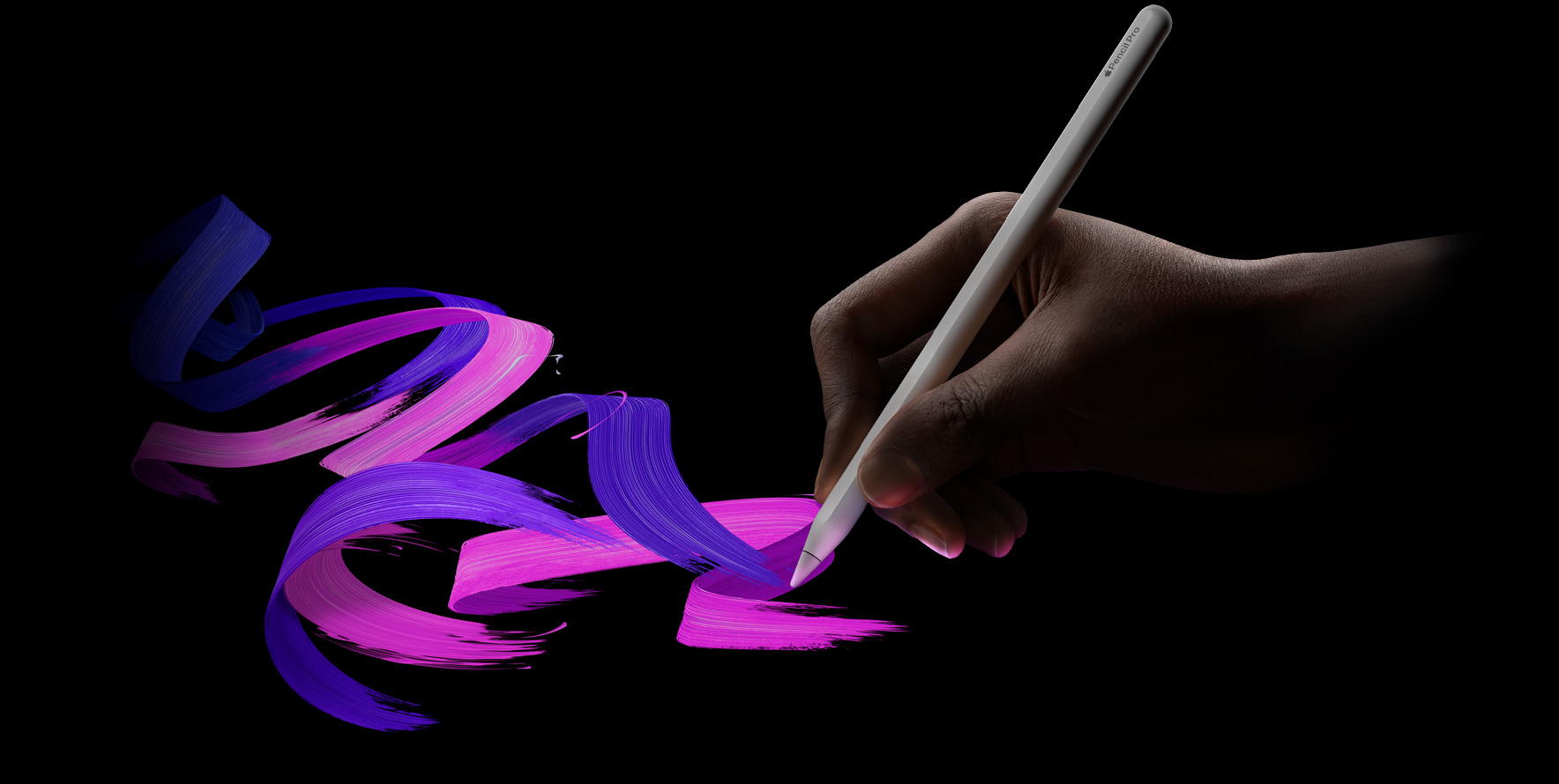 Un usuario sostiene un Apple Pencil Pro, seguido de un trazo de pincel en colores vibrantes