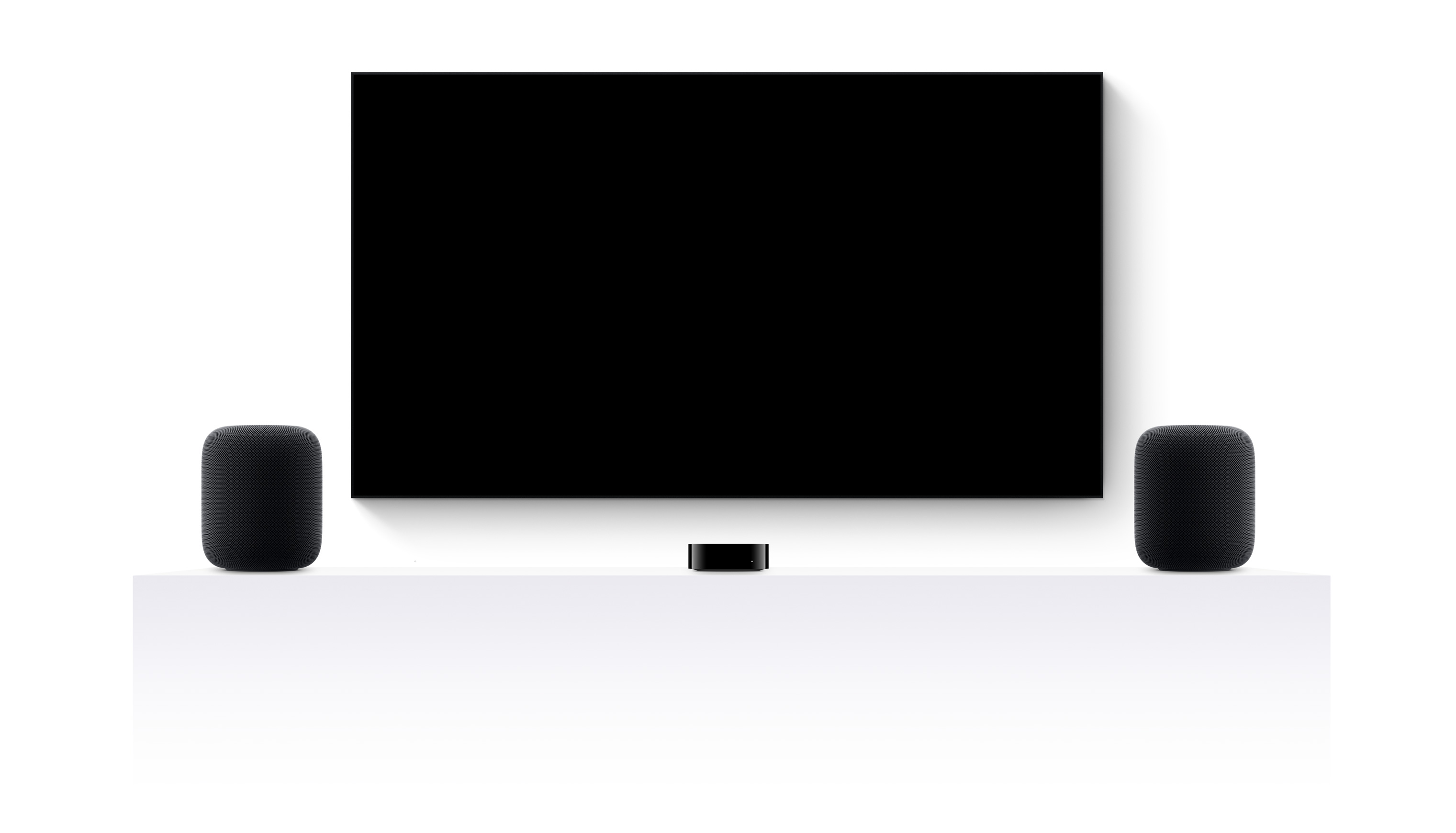 Apple TV 4k, two HomePods, and a flatscreen television showing an edited trailer of various Apple TV+ movies and shows