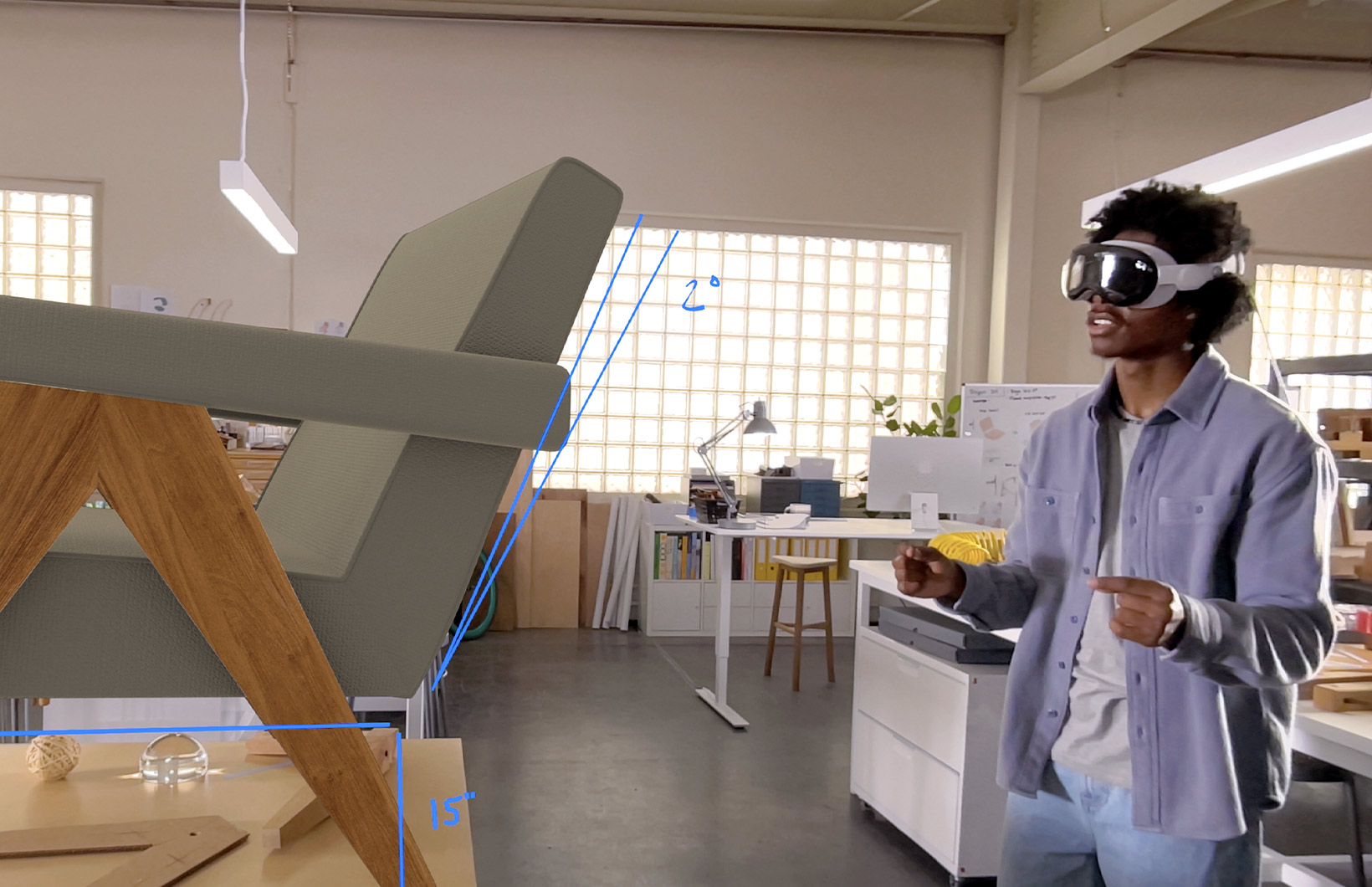 A person using Apple Vision Pro to work on a virtual piece of furniture in their workspace