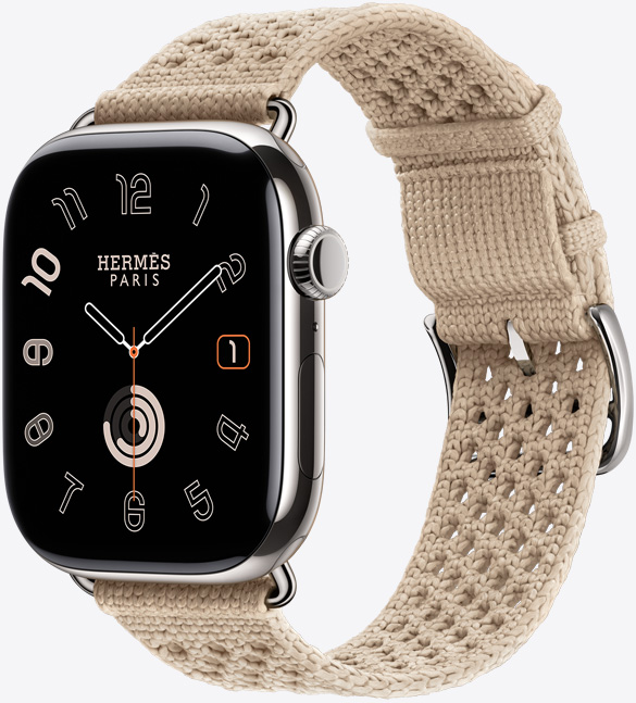 Apple Watch Hermès Series 11, caja de titanio, color plata, acabado pulido, pantalla de borde a borde, esquinas redondeadas, lateral derecho, Digital Crown, micrófono, botón lateral, esfera Circulaire (aguja horaria, minutero y segundero, logotipo de Hermès París), con la correa Néo Tricot, color Argile (beis), confeccionada con hilo de poliamida tejido, orificios de ajuste en el centro, hebilla y componentes en plata