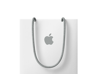 Appleの白いショッピングバッグ。グレイの持ち手と、中央にグレイのAppleのロゴが付いている
