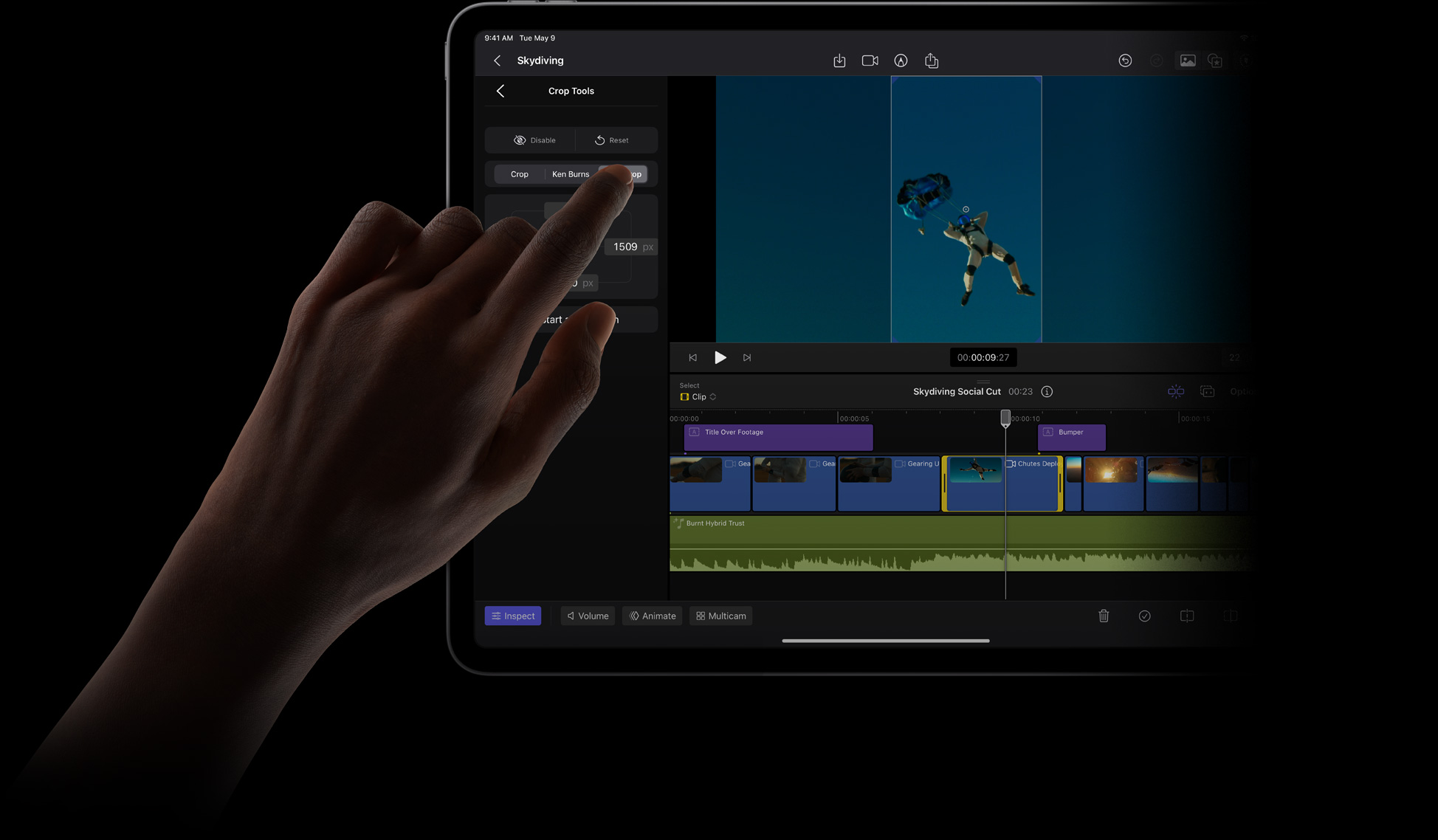 Finger touching iPad Pro display to select an item from the Crop Tools menu in Final Cut Pro.