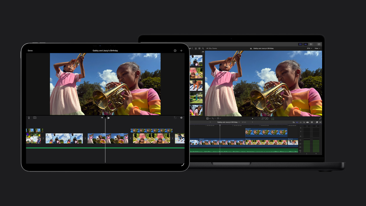 A tela do MacBook Pro de 14 polegadas mostra duas meninas tocando trompete ao ar livre, demonstração da importação do iMovie, clipes, tela do iPad Pro de 13 polegadas mostrando duas meninas tocando trompete ao ar livre, demonstração da importação do iMovie, clipes na parte inferior