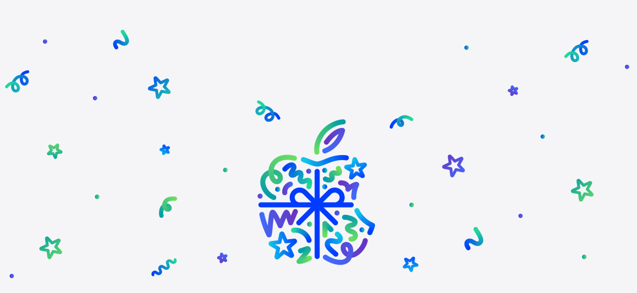 Dot, squiggle, spiral and star shapes in different hues of blue, green and purple burst and spread across from behind Apple logo, wrapped in a blue colour bow, made up of dots, squiggles, spirals and star shapes in different hues of blue, green and purple