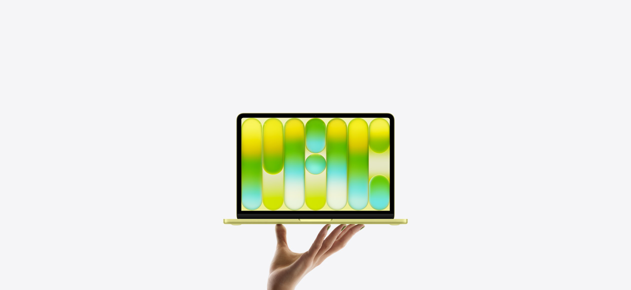 MacBook Neo in bright citrus colour, balanced on fingertips of open hand, screen displaying colourful abstract pattern