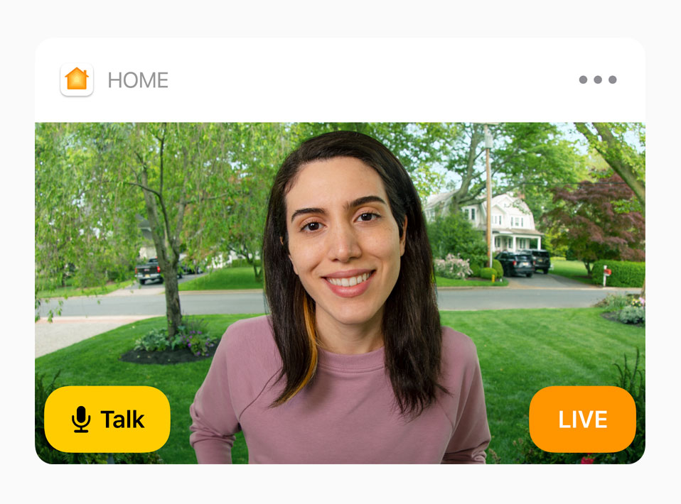 View of a doorbell camera shows a woman in a pink sweatshirt. The words “Talk” and “Live” are on screen.