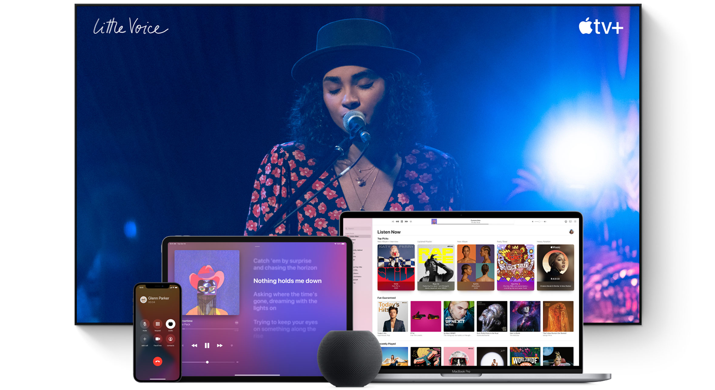 Large TV screen with a woman singing. A MacBook Pro, an iPad, an iPhone, and a Space Gray HomePod mini are arranged in front.