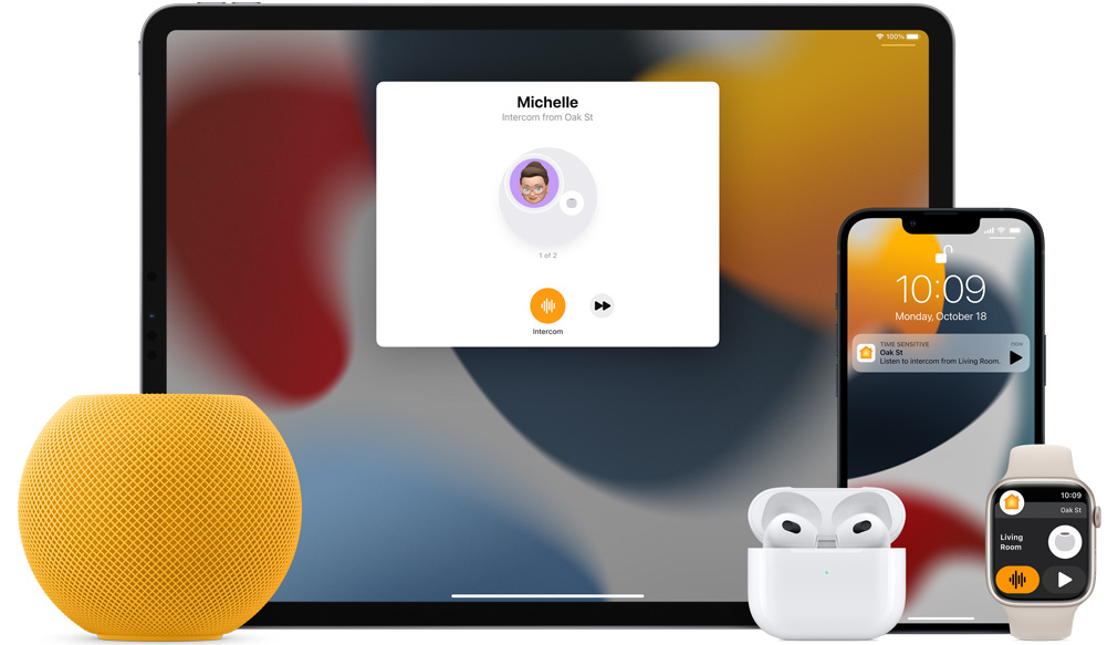 Yellow HomePod mini, an iPad, AirPods in a case, an iPhone, and an Apple Watch with a pink band are arranged.