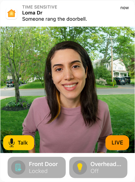 View of a doorbell camera shows a woman in a pink sweatshirt. The words “Talk” and “Live” are on screen.