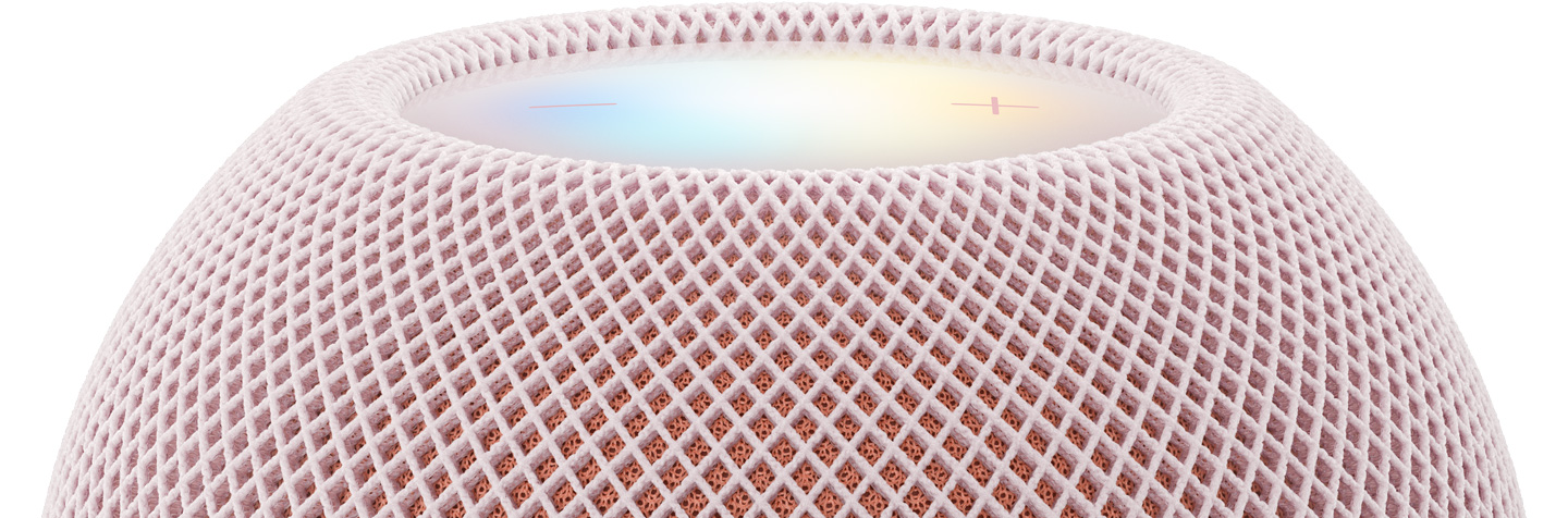 Un HomePod mini 2, rose, face supérieure, surface tactile rétroéclairée par le halo multicolore de Siri AI