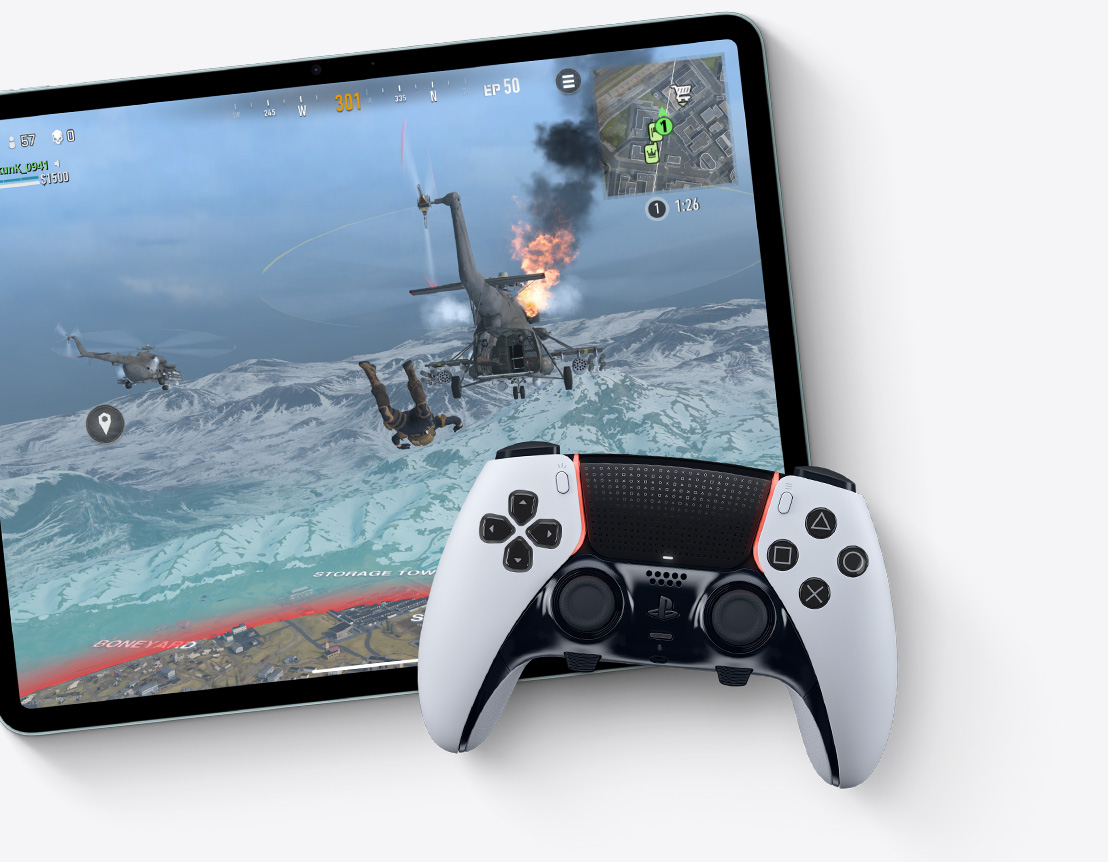 iPad Air 화면에서 "콜 오브 듀티: 워존" 게임을 보여주고 그 위에는 외부 컨트롤러가 놓여진 모습.