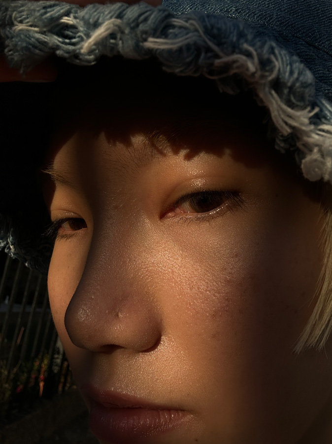 A close-up selfie of a woman's face, revealing incredible detail, taken with the TrueDepth camera.
