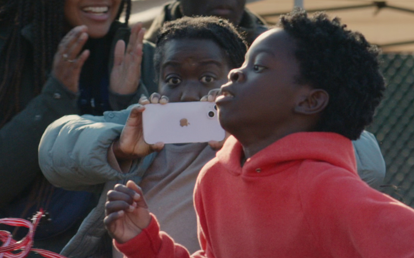 A still-life shot of a parent using Action mode to capture her son's school sports race.