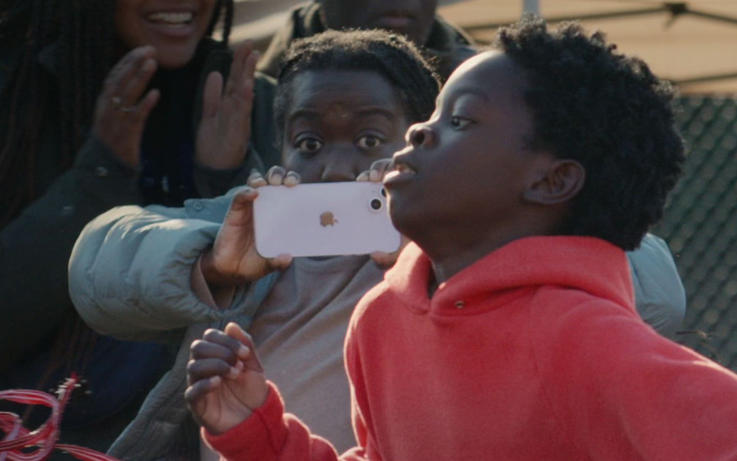 A still-life shot of a parent using Action mode to capture her son's school sports race.