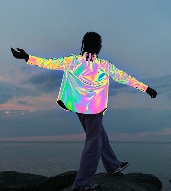 A photo of a man wearing a reflective, metallic jacket, taken with the TrueDepth camera