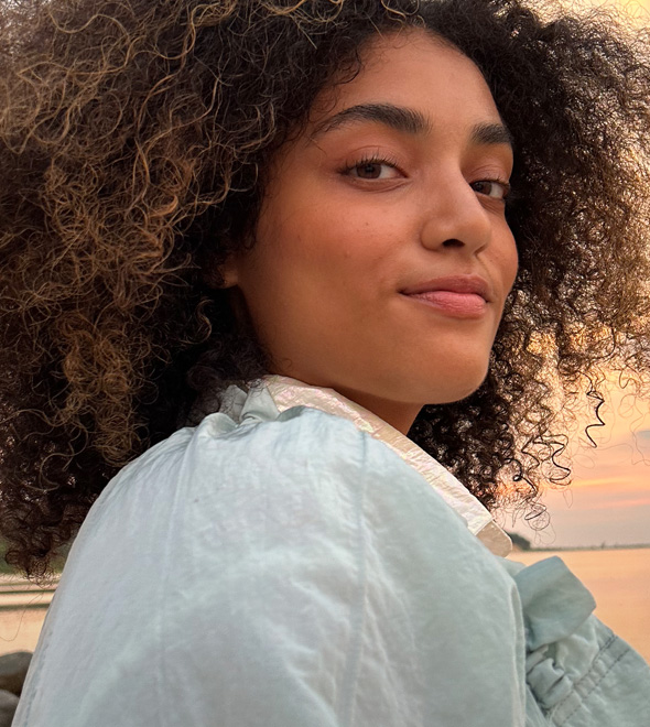 A vibrant portrait of someone during sunset looking at the lens, taken with the TrueDepth camera