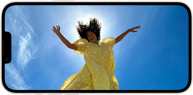 A photo of a person jumping into the air on a bright, sunny day. The Super Retina XDR display makes the image look sharp, vibrant, and true to life.