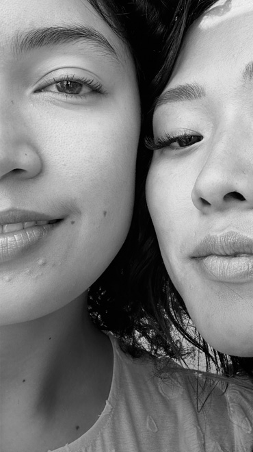 An upclose, black and white selfie of two people smiling, taken with the TrueDepth camera