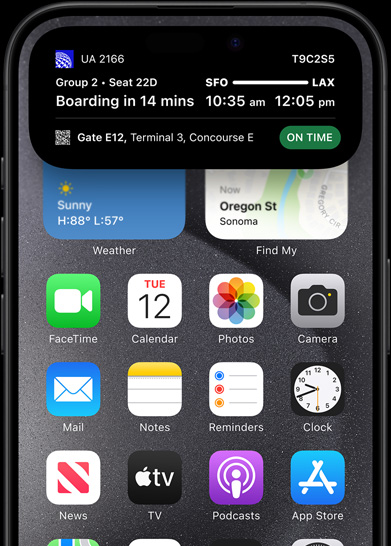 iPhone 15 Pro with Dynamic Island showing live sports scores